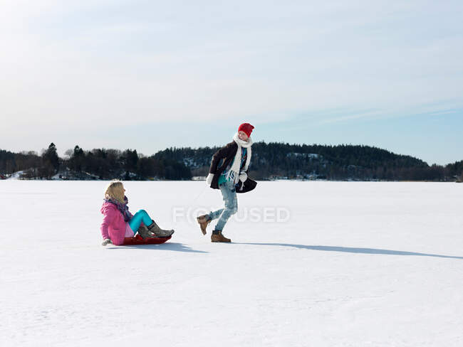 Couple with snow sledge — Stock Photo