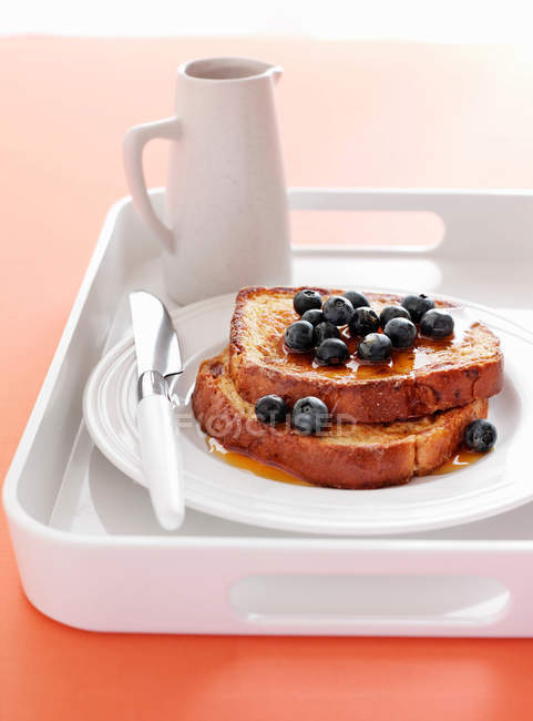 Close-up view of french toasts with blueberries and honey — Stock Photo