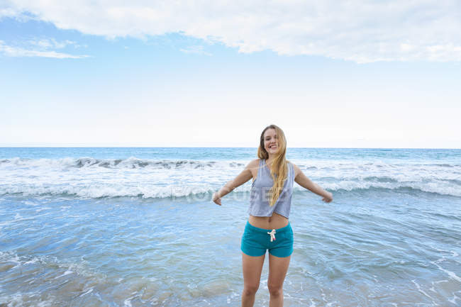 Portrait of young woman with arms open in sea, Dominican Republic, The Caribbean — Stock Photo