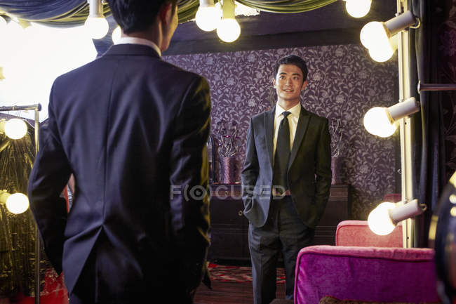 Young male client trying on new suit in traditional tailors shop — Stock Photo