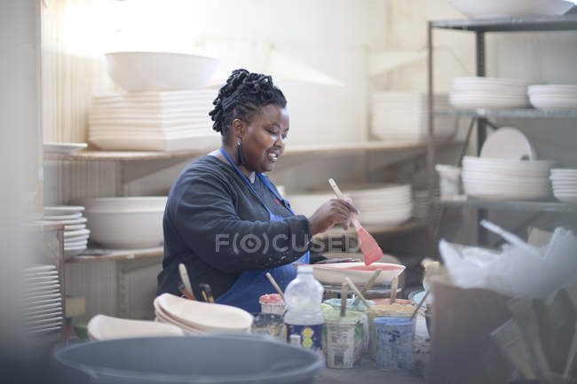 Potter preparing paint at crockery factory — Stock Photo