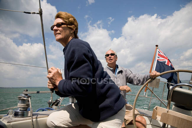Mature couple sailing yacht — Stock Photo