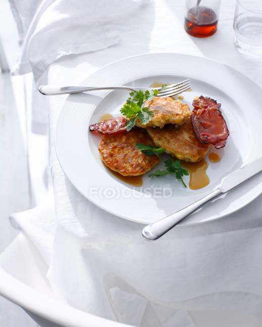 Plate of corn fritters with bacon — Stock Photo