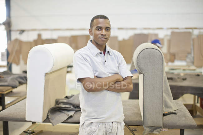Portrait of young male upholsterer in workshop — Stock Photo