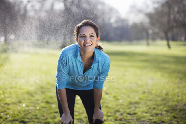 Portrait of young woman taking training break in park — Stock Photo