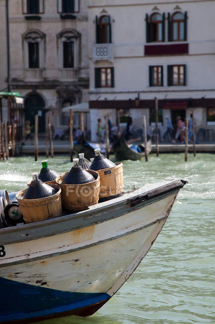 Wine containers on boat, grand canal, venice, italy — Stock Photo