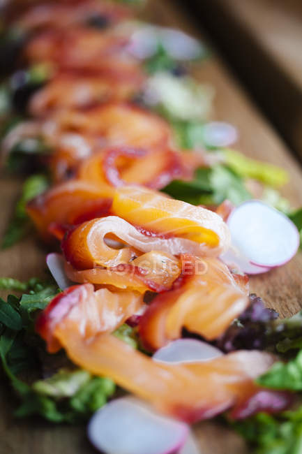 Close up of Gravlax salmon salad on wooden board — Stock Photo