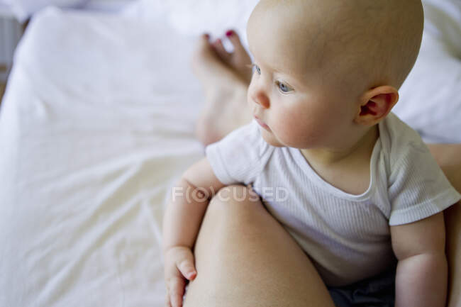 Baby girl on mother's lap — Stock Photo