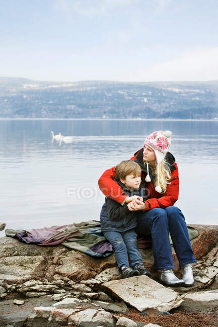 Мать и сын отдыхают на озере — стоковое фото