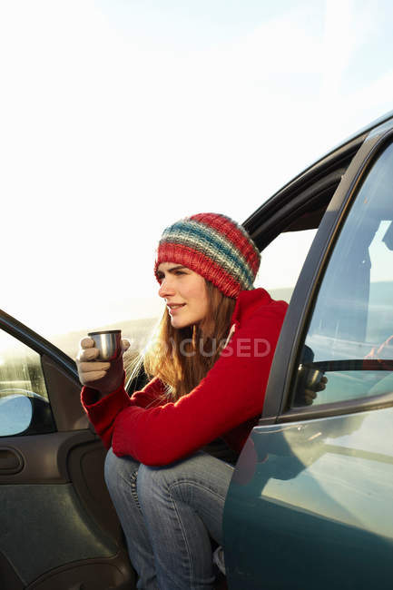 Woman drinking coffee from thermos — Stock Photo