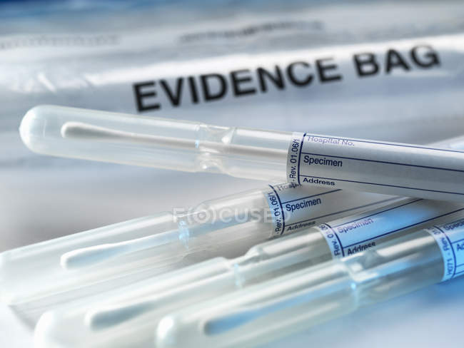 Close up of Row of samples from crime scene on top of genetic testing results — Stock Photo