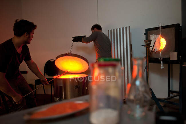 Two men working in glass factory — Stock Photo