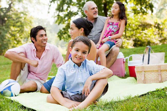 Three generation family at picnic in park, portrait — Stock Photo