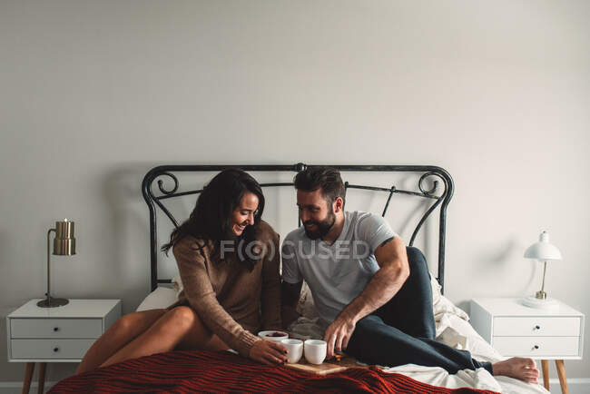 Romantic couple having breakfast in bed — Stock Photo
