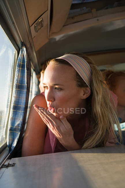 A young woman blowing a kiss — Stock Photo