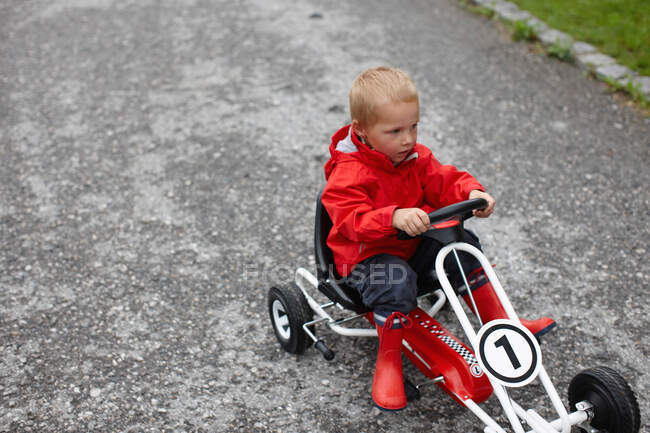 Toddler boy riding go-cart — Stock Photo