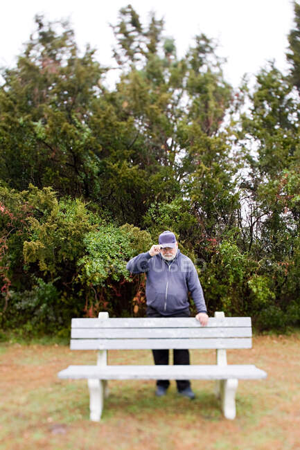 Man leaning on a bench — Stock Photo