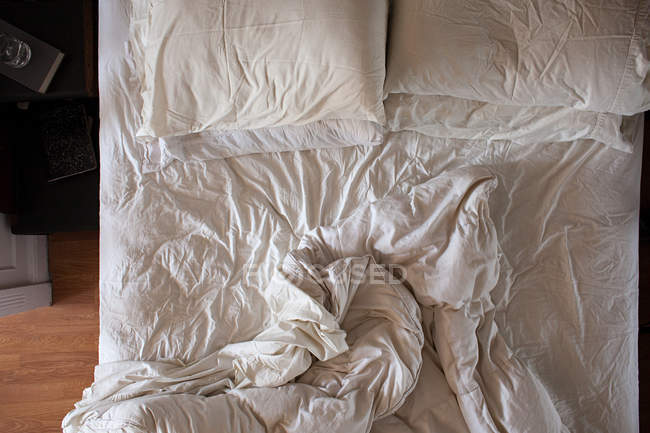 Top view of empty unmade bed — Stock Photo