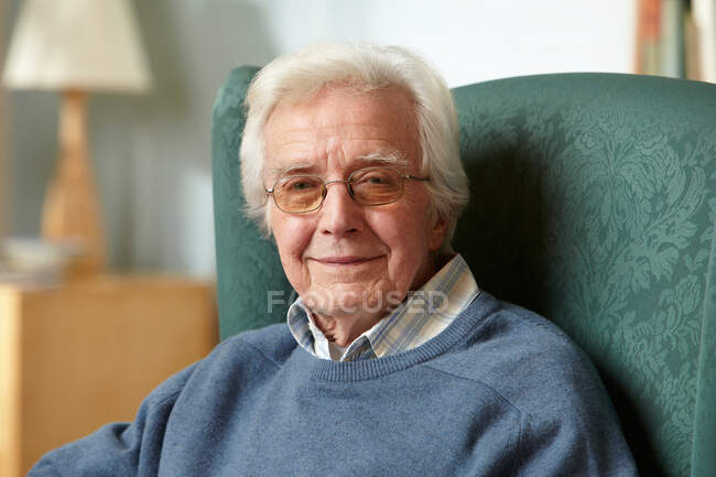 Uomo anziano in poltrona, ritratto — Foto stock