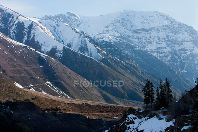Aerial view of snowy mountain range in sunlight — Stock Photo