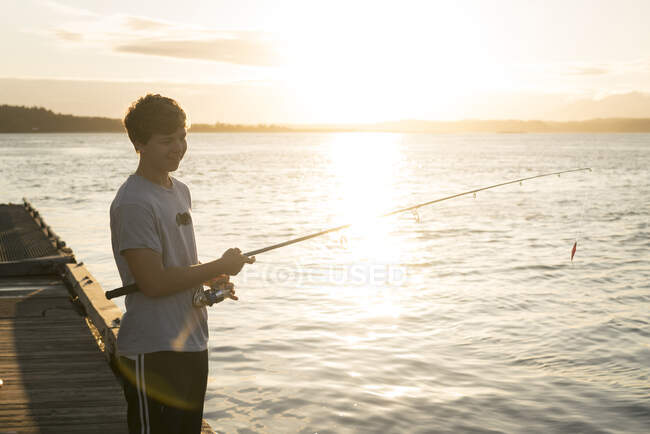 Teenage boy fishing, Pacific Rim National Park, Vancouver Island, Canada — Stock Photo