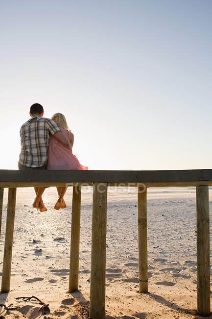 A couple sat on a pier — Stock Photo