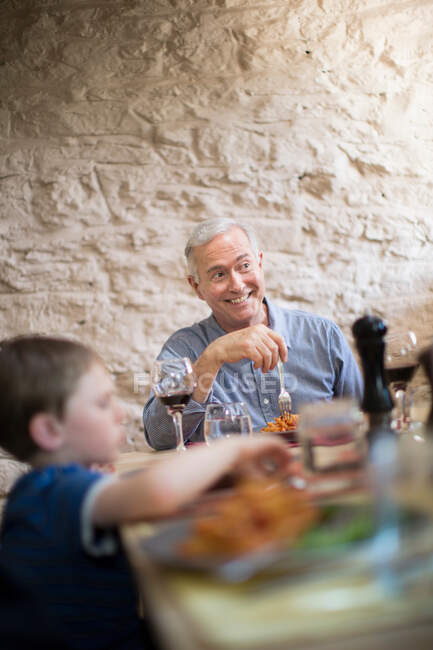 Grandfather and grandson at meal time — Stock Photo