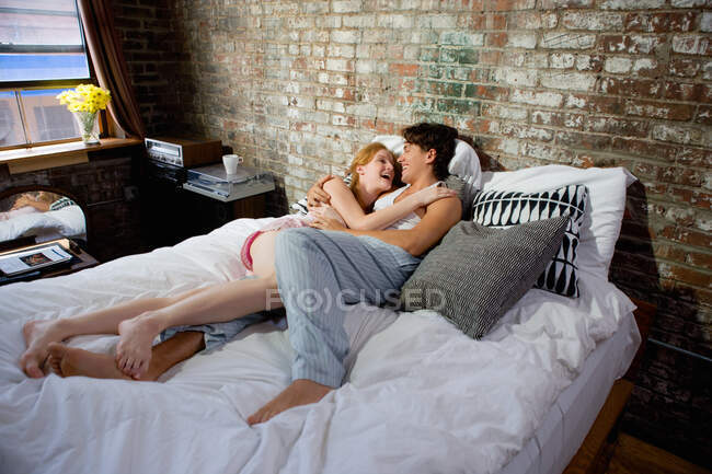 Couple hugging in bed — Stock Photo