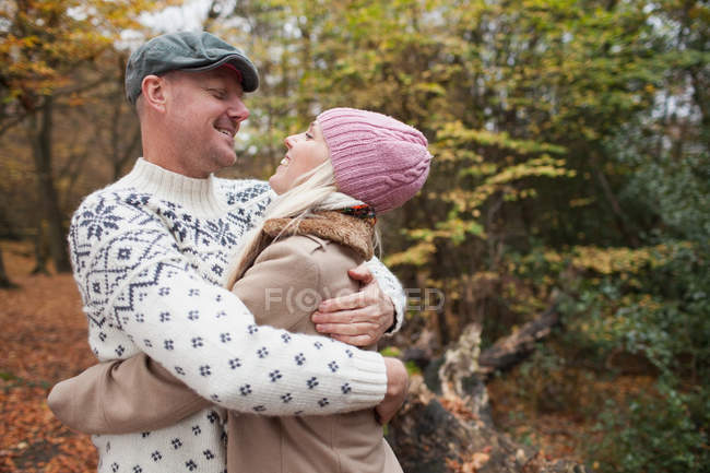 Couple hugging in park, half length — Stock Photo
