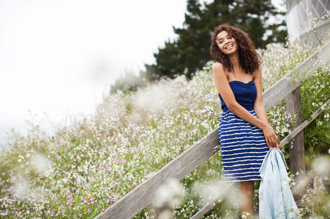 Young woman laughing by meadow — Stock Photo