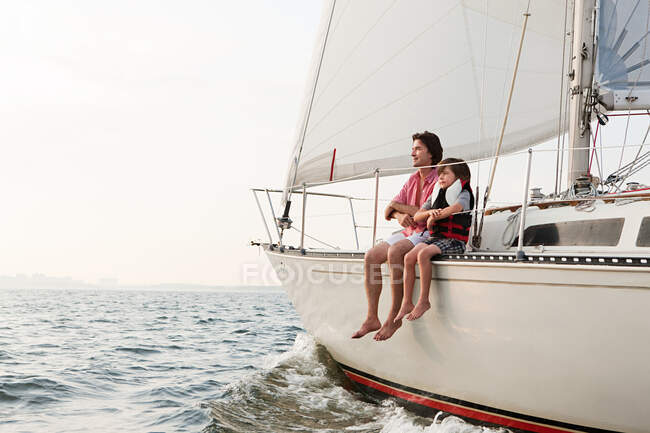Father and son sitting on yacht — Stock Photo