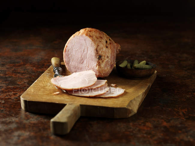 Carved ham on kitchen table — Stock Photo