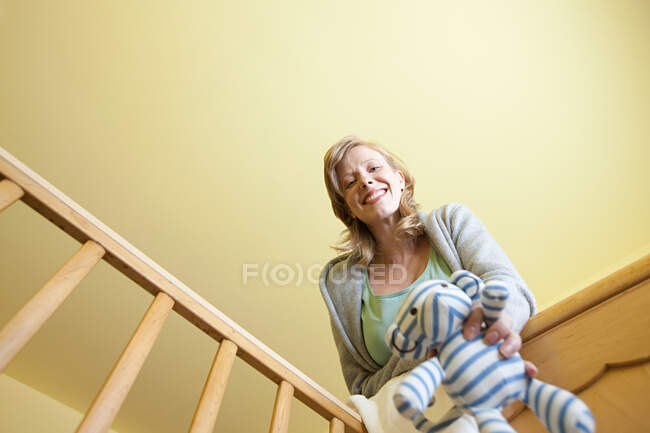 Woman looking in to crib — Stock Photo