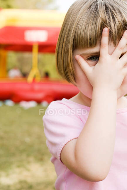 Girl with hand in front of face — Stock Photo