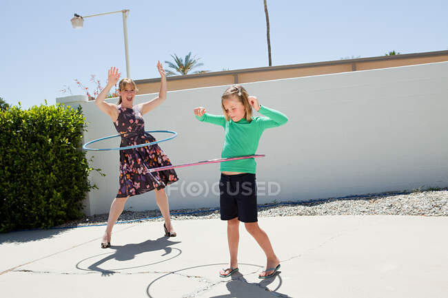 Mother and daughter with hoola hoops — Stock Photo