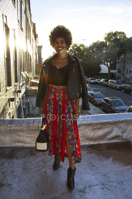 Portrait of young female fashion blogger on sunlit terrace, New York, USA — Stock Photo