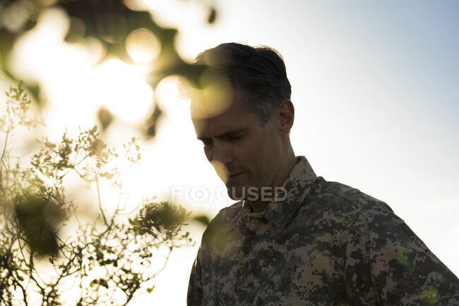 Portrait of soldier wearing combat clothing looking down, Runyon Canyon, Los Angeles, California, USA — Stock Photo