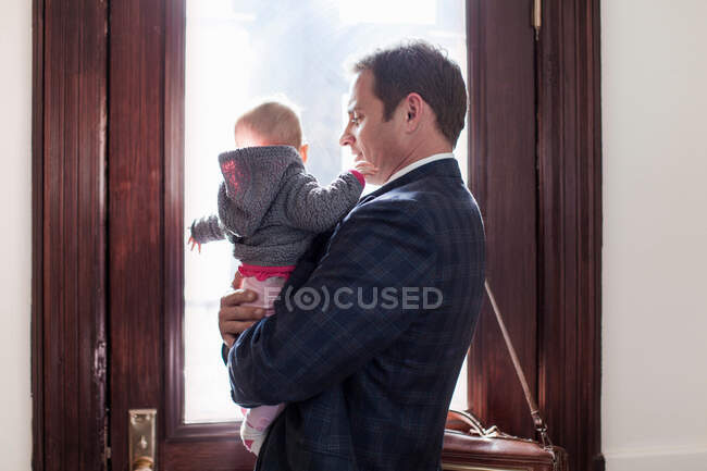 Empresário segurando bebê filha — Fotografia de Stock