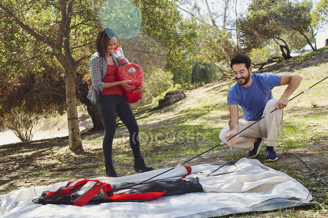 Couple camping, erecting their tent — Stock Photo