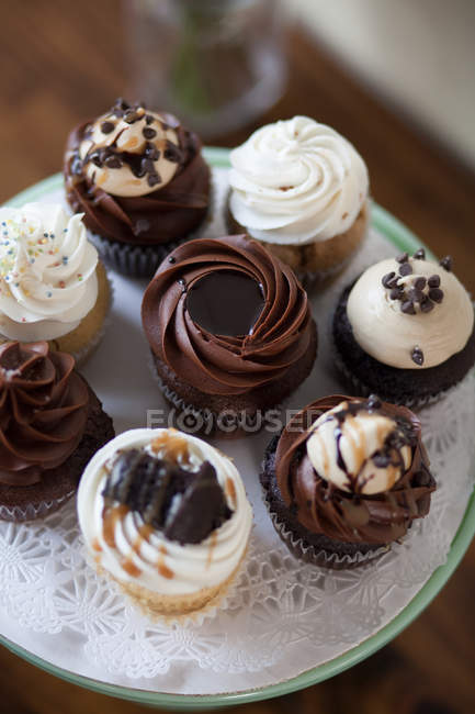 Cupcakes decorated with cream on cakestand — Stock Photo