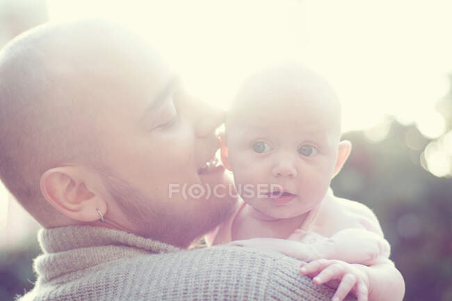 Father whispering to baby — Stock Photo