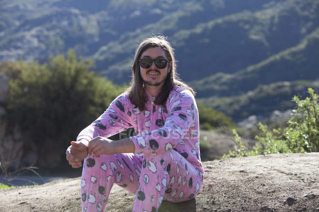 Portrait of man wearing pink onesie, Malibu Canyon, California, USA — Stock Photo