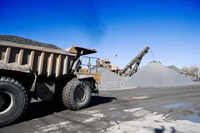 Coal mining and transport against hills — Stock Photo