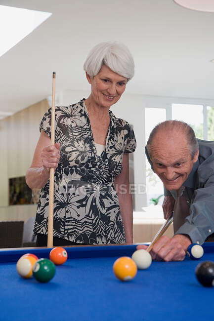Старшая пара играет в бильярд — стоковое фото