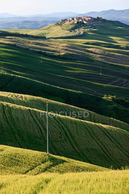 Hillside landscape with town in distance — Stock Photo