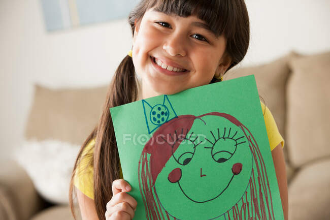 Girl holding picture of face — Stock Photo