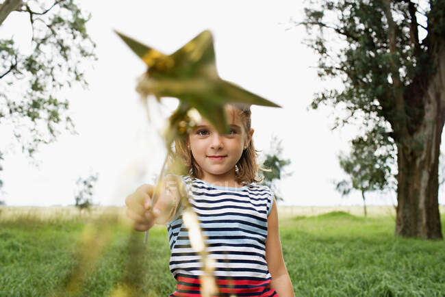 Girl playing with a wand — Stock Photo