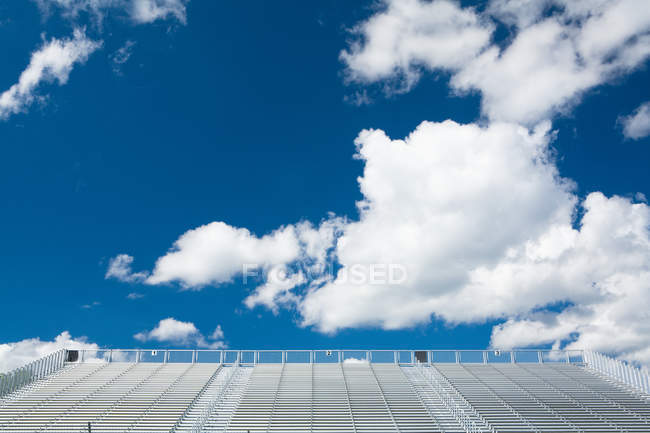 Sky and clouds above stadium seats — Stock Photo