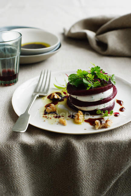 Stacked beetroot and goat cheese salad — Stock Photo