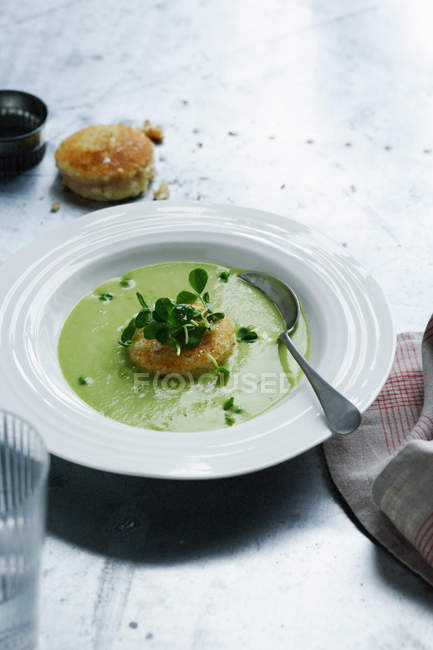 Bowl of pea soup with crackers — Stock Photo